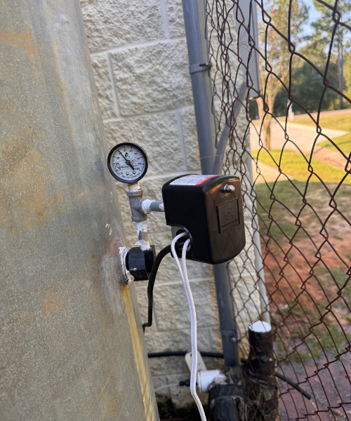 A meter attached to a chain link fence