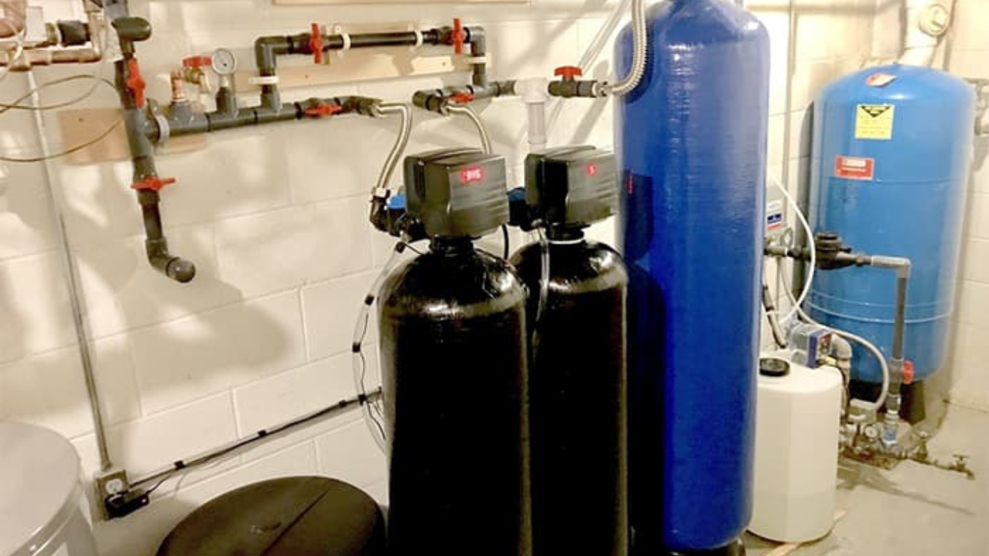 A couple of water tanks sitting next to a toilet